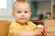 Kind hält Apfel in der Hand